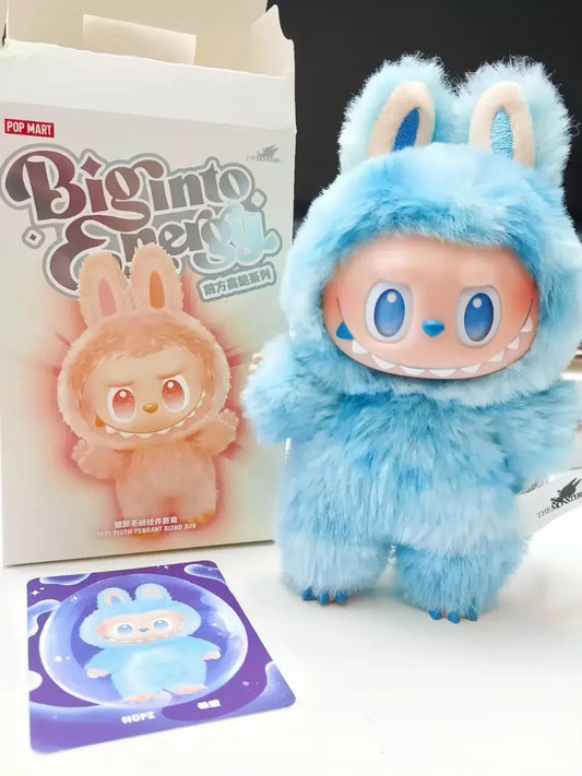 Blue plush toy with bunny ears next to a Bigintoto box and card